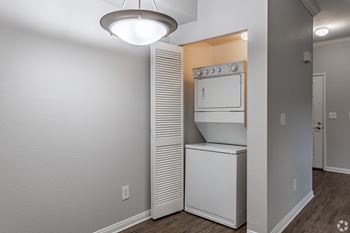 A small kitchen with a white oven and a white fridge.